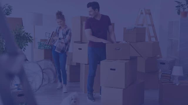 A happy military couple prepares moving boxes for their upcoming PCS.