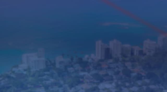 Aerial view of a coastal neighborhood with homes and low-rise buildings along the waterfront