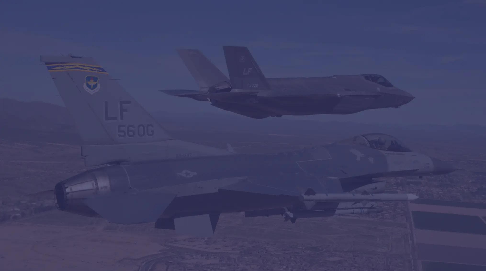 An F-35 and F-16 fly in formation over Luke AFB near Phoenix, AZ