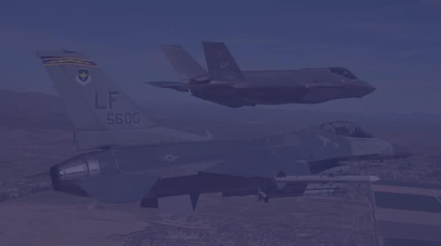 An F-35 and F-16 fly in formation over Luke AFB near Phoenix, AZ