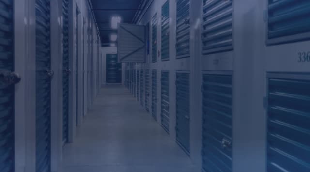 A hallway of locked storage units at a temporary storage facility
