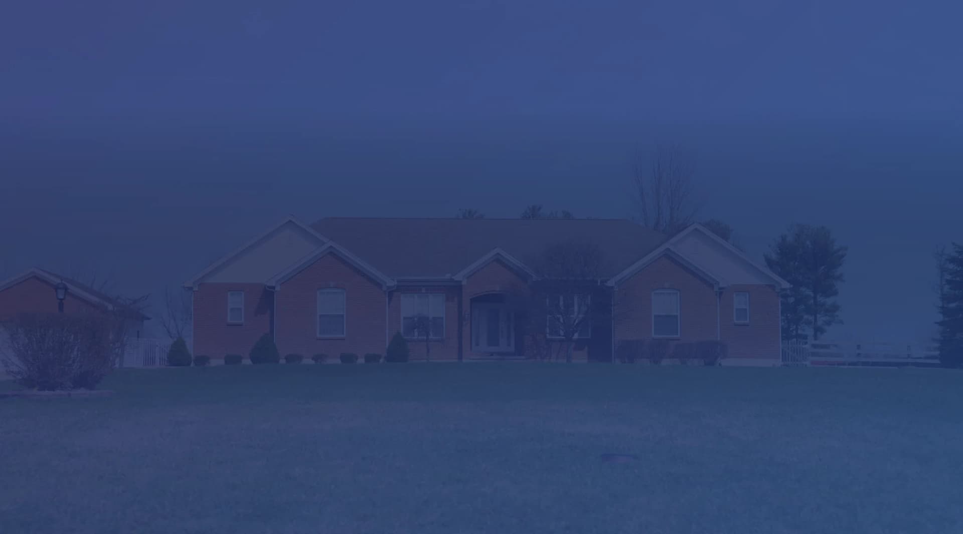 A brick single-family home with a green front lawn, the kind of property a military buyer might take over through a VA loan assumption.
