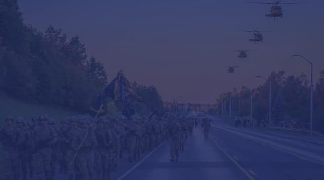 U.S. Army troops do a company run down the road.