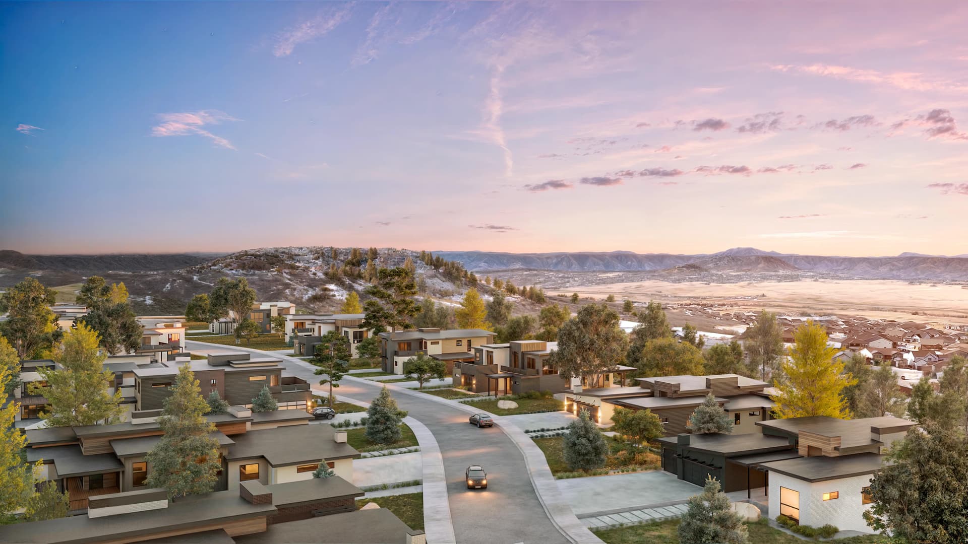 A sweeping view of the Crystal Valley community at sunset, showcasing the ridge line and distant mountains.