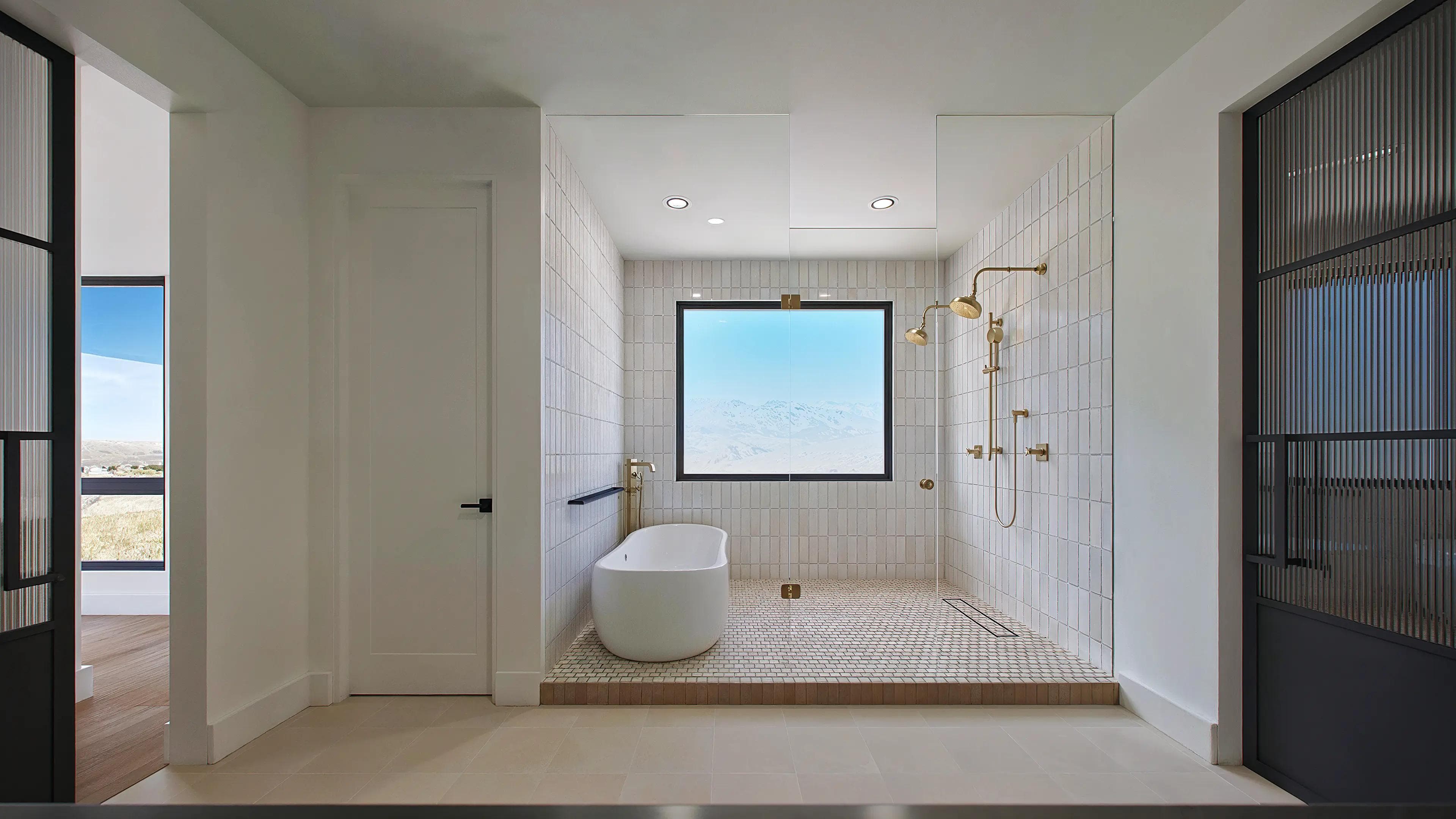 A luxurious full bath with golden shower head and full view of Castle Rock, CO.