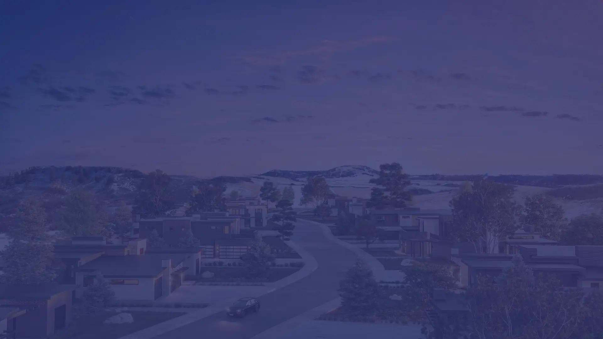 A sweeping view of the Crystal Valley community at sunset, showcasing the ridge line and distant mountains.