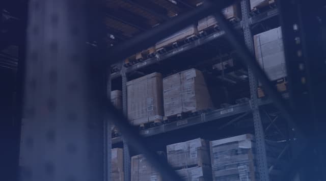 Pallet racking stacked with boxed household goods inside a long-term storage warehouse