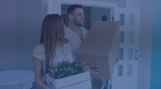 Military family moving boxes into a new home during a PCS