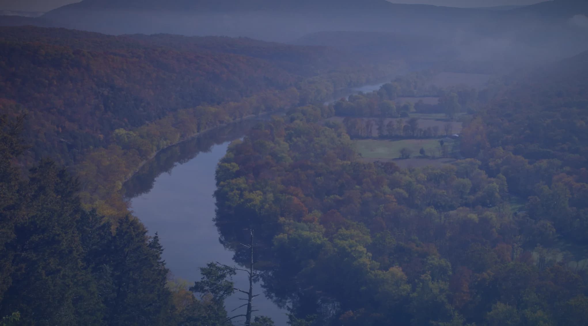 A river winding through a forested Maryland valley in autumn.
