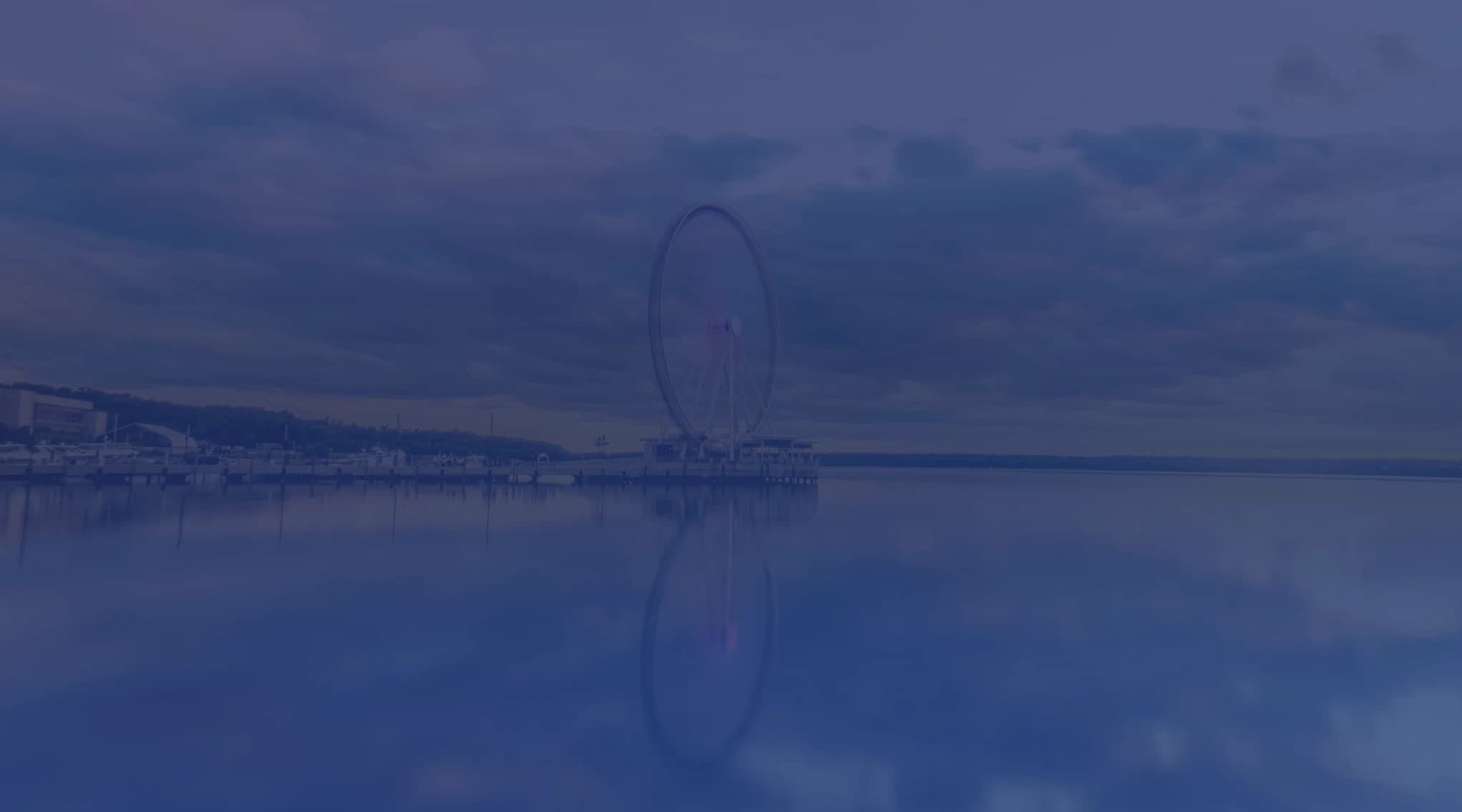 The Capital Wheel ferris wheel reflected in the Potomac River at National Harbor, Maryland, near Joint Base Andrews