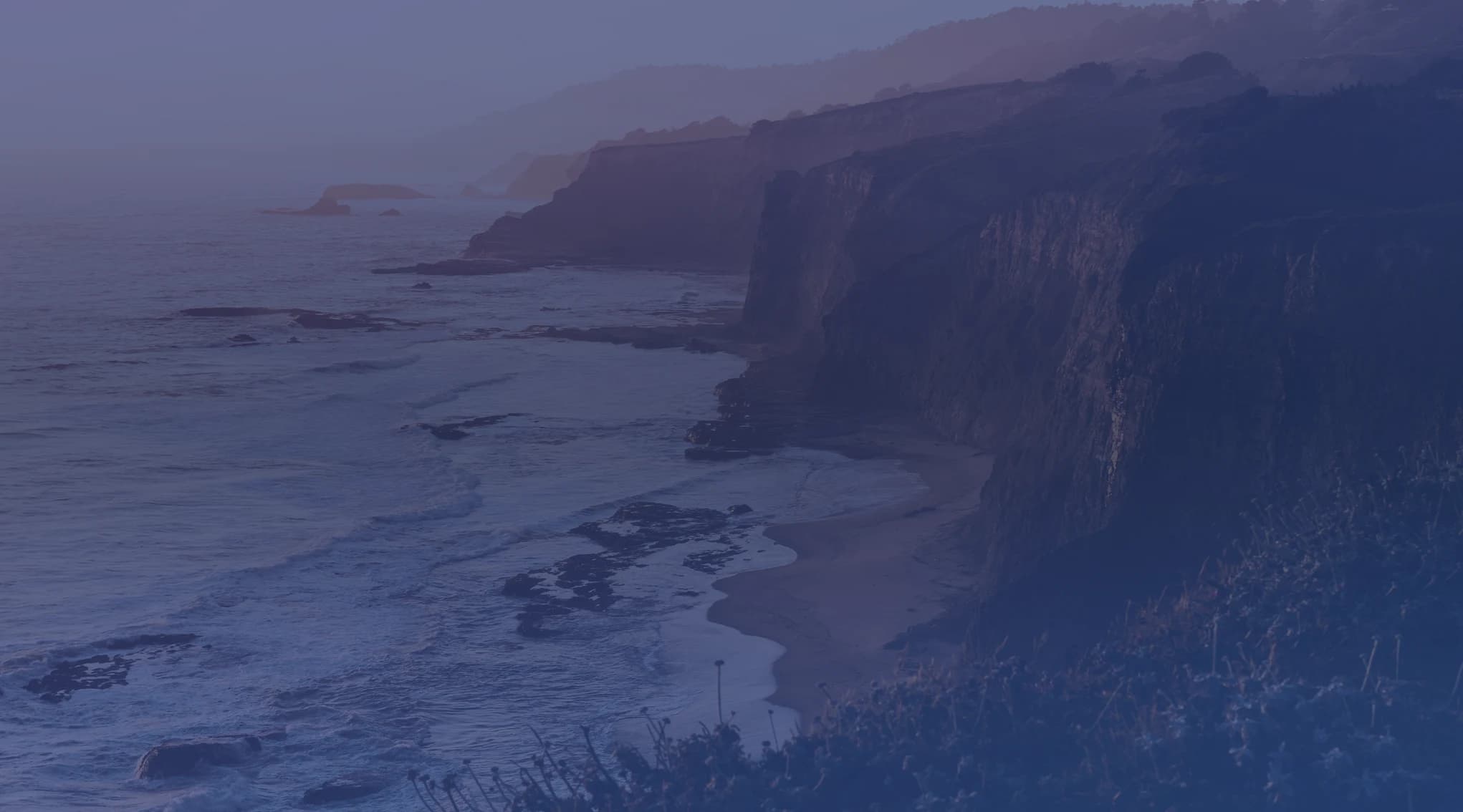 California coastal bluffs bathed in golden-hour light above the Pacific Ocean, near Ventura County
