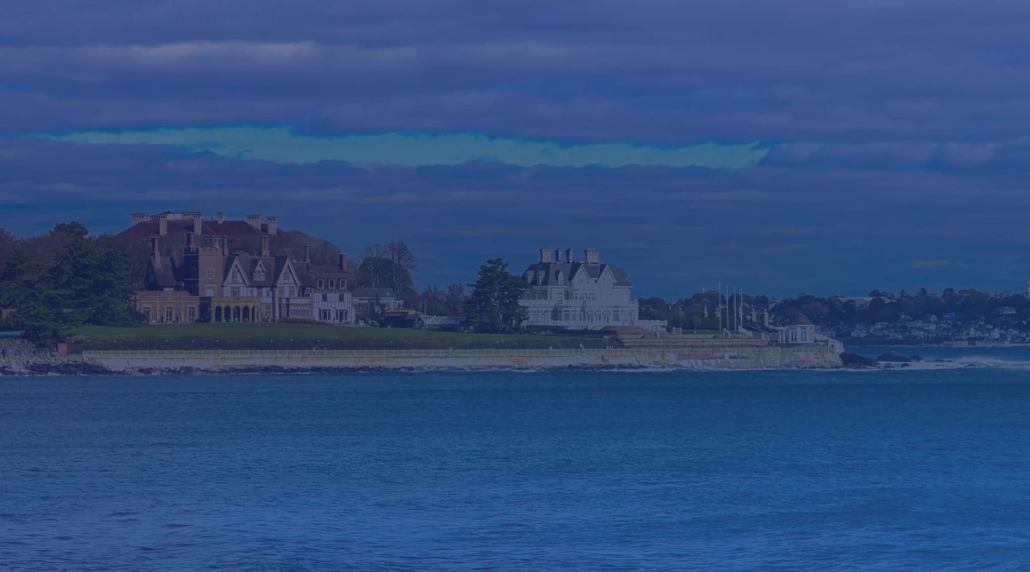 Newport mansions and historic estates viewed from Narragansett Bay on a clear coastal New England day