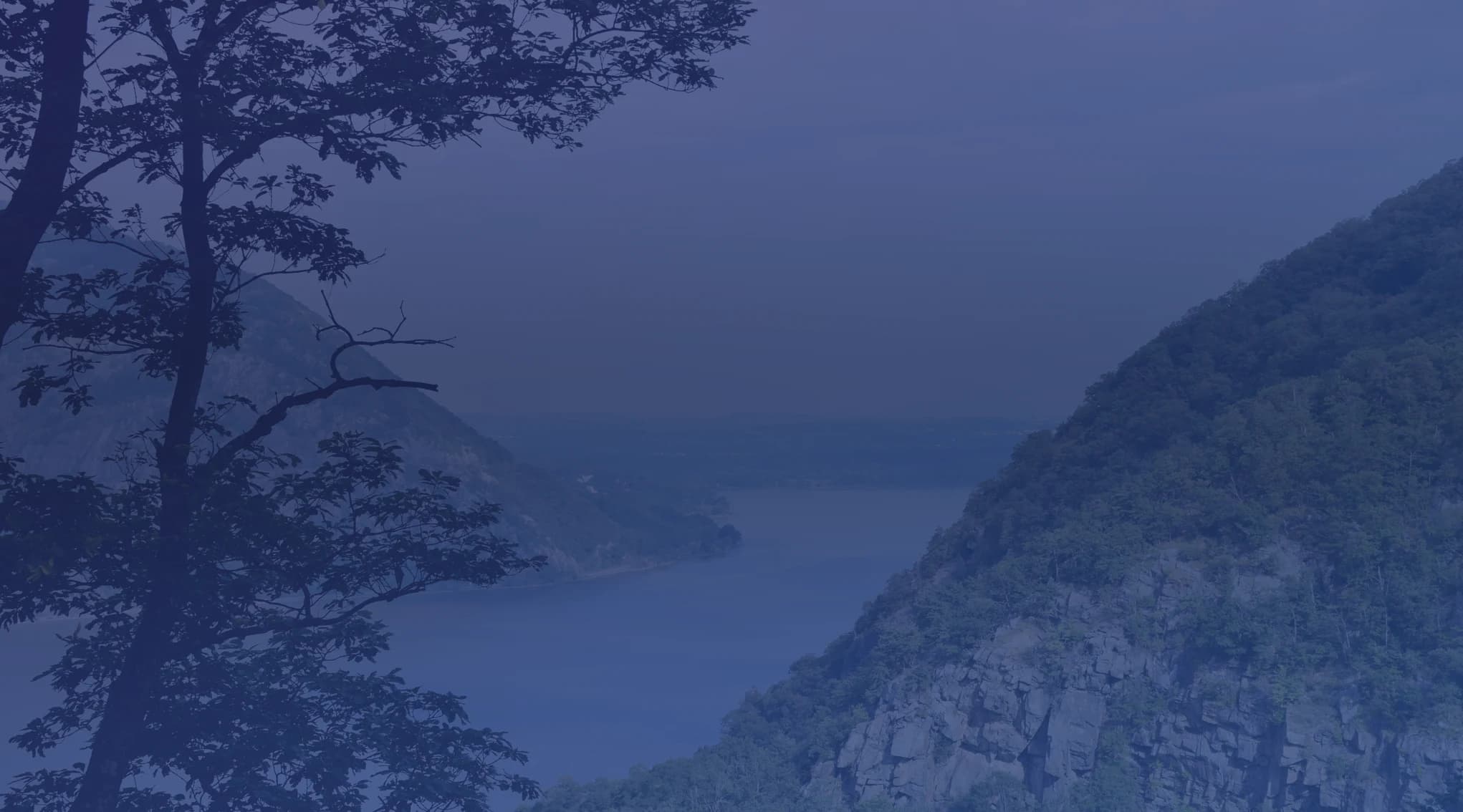The Hudson River winding between forested green mountains in the Hudson Valley near Cold Spring, New York, close to West Point