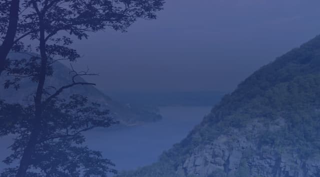 The Hudson River winding between forested green mountains in the Hudson Valley near Cold Spring, New York, close to West Point