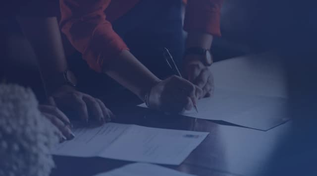 Person reviewing real estate closing documents at a desk