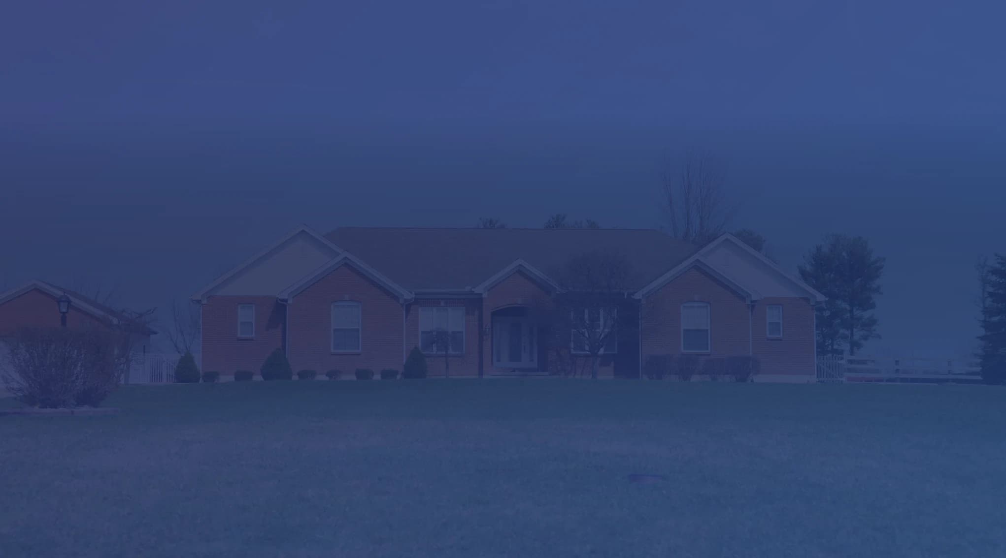 A brick single-family home with a green front lawn, the kind of property a military buyer might take over through a VA loan assumption.