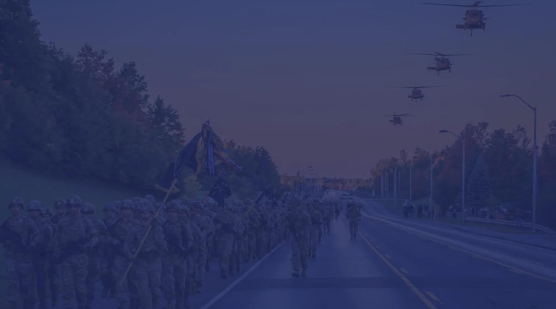 U.S. Army troops do a company run down the road.