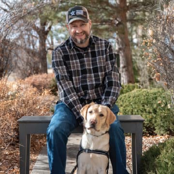 A yellow lab provided to a veteran by Freedom Service Dogs of America